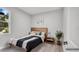 Serene bedroom with natural light, a minimalist decor, and a comfortable bed, creating a calming space at 1117 Vernon Ave, Port Charlotte, FL 33948
