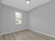 A bright and airy bedroom featuring gray walls and new vinyl flooring at 1117 Vernon Ave, Port Charlotte, FL 33948