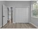 Bright bedroom with a large closet featuring four doors at 1117 Vernon Ave, Port Charlotte, FL 33948
