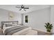 Bright bedroom featuring neutral decor, a ceiling fan, and a comfortable bed for a relaxing space at 1117 Vernon Ave, Port Charlotte, FL 33948