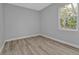 A simple bedroom has a light and airy feel with views of the surrounding nature at 1117 Vernon Ave, Port Charlotte, FL 33948