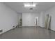 The spacious epoxy-floored two-car garage features bright lighting, an interior door, and white concrete walls at 1117 Vernon Ave, Port Charlotte, FL 33948