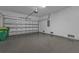 Spacious two-car garage with an epoxy floor, overhead lighting, and white-painted concrete walls at 1117 Vernon Ave, Port Charlotte, FL 33948