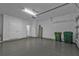 The spacious two-car garage has bright overhead lighting, an epoxy floor, and a connected interior door at 1117 Vernon Ave, Port Charlotte, FL 33948