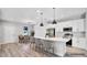 Open-concept kitchen with a large island, modern appliances, white cabinets, and adjacent dining area for seamless entertaining at 1117 Vernon Ave, Port Charlotte, FL 33948