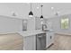 Kitchen island with stainless steel appliances and a view to the living room at 1117 Vernon Ave, Port Charlotte, FL 33948