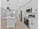 Bright kitchen with stainless appliances and eat-in island and ample cabinet space at 1117 Vernon Ave, Port Charlotte, FL 33948