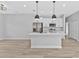 Bright kitchen featuring an island, stainless steel appliances and modern pendant lighting at 1117 Vernon Ave, Port Charlotte, FL 33948