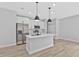 Modern kitchen with an island, stainless steel appliances, and white cabinets and countertop at 1117 Vernon Ave, Port Charlotte, FL 33948