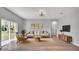 Bright living room featuring a neutral color palette, stylish furniture, and natural light from a sliding glass door at 1117 Vernon Ave, Port Charlotte, FL 33948