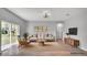 Bright, neutral living room featuring a comfortable sofa, stylish decor, and sliding glass doors at 1117 Vernon Ave, Port Charlotte, FL 33948