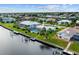 This aerial view shows canal-front home, screen-enclosed pool, boat lift and waterfront access at 1118 Treasure Cay Ct, Punta Gorda, FL 33950