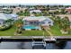 Aerial view showcasing the pool, lanai, private dock, and waterfront canal at 1118 Treasure Cay Ct, Punta Gorda, FL 33950