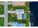 Top-down aerial view showcasing the pool, lanai, and private dock on a canal at 1118 Treasure Cay Ct, Punta Gorda, FL 33950