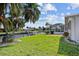Waterfront backyard featuring mature palm trees overlooking channel with private dock at 1118 Treasure Cay Ct, Punta Gorda, FL 33950