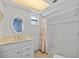 Bright bathroom features a vanity with marble countertop and walk-in shower at 1118 Treasure Cay Ct, Punta Gorda, FL 33950