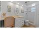 Well lit bathroom featuring vanity area and walk-in shower with beach themed decor at 1118 Treasure Cay Ct, Punta Gorda, FL 33950