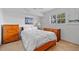 Cozy bedroom with wood furniture, bright walls, tile floors and ample natural light at 1118 Treasure Cay Ct, Punta Gorda, FL 33950