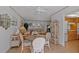 Bright dining area adjacent to living room with white rattan furniture and a glass top table at 1118 Treasure Cay Ct, Punta Gorda, FL 33950