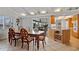 Open concept dining room with views of the lanai, neutral decor, and adjacent kitchen island at 1118 Treasure Cay Ct, Punta Gorda, FL 33950