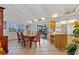 Open concept dining room with adjacent kitchen and bright white design and high ceilings at 1118 Treasure Cay Ct, Punta Gorda, FL 33950