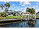 Waterfront house featuring an enclosed lanai and private dock along a waterway at 1118 Treasure Cay Ct, Punta Gorda, FL 33950