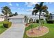 Inviting home with lush landscaping, palm trees, and white exterior at 1118 Treasure Cay Ct, Punta Gorda, FL 33950