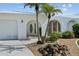 Charming home featuring a stucco exterior, meticulously maintained landscaping, and a welcoming entrance at 1118 Treasure Cay Ct, Punta Gorda, FL 33950