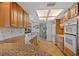 Bright kitchen featuring wooden cabinets, granite counters, and stainless appliances at 1118 Treasure Cay Ct, Punta Gorda, FL 33950