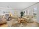Inviting living room with neutral paint, tile floors, and bright, natural light at 1118 Treasure Cay Ct, Punta Gorda, FL 33950