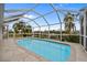 Backyard pool and canal view surrounded by mature landscaping in screened enclosure at 1118 Treasure Cay Ct, Punta Gorda, FL 33950