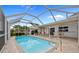 Screened pool with comfortable seating and view of backyard landscaping and patio at 1118 Treasure Cay Ct, Punta Gorda, FL 33950