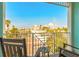 Balcony with seating overlooking the ocean, palm trees, and local community at 11723 1St E St, Treasure Island, FL 33706