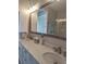 Bright bathroom features double sinks, quartz counters, and large mirror with decorative fixtures at 11723 1St E St, Treasure Island, FL 33706