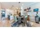 Bright dining area featuring modern lighting, stylish decor, and views of the adjacent open kitchen at 11723 1St E St, Treasure Island, FL 33706