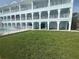 Spacious three-story condo with multiple balconies overlooking a lush lawn and providing outdoor living spaces at 11723 1St E St, Treasure Island, FL 33706