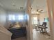 Hallway leading to the office space with hardwood floors and natural light at 11723 1St E St, Treasure Island, FL 33706