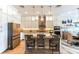 Bright kitchen with stainless steel appliances, stone countertops, island seating, and ample cabinet storage at 11723 1St E St, Treasure Island, FL 33706
