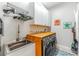 Bright laundry room features a utility sink, modern washer/dryer, and storage at 11723 1St E St, Treasure Island, FL 33706
