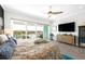 Main bedroom with a king-size bed, water views, TV and dresser, plus access to a private balcony at 11723 1St E St, Treasure Island, FL 33706