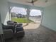 Charming covered patio with comfortable seating, offering picturesque waterfront views and a tranquil outdoor space at 11723 1St E St, Treasure Island, FL 33706