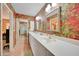 Spacious bathroom with a double vanity, walk-in closet, and large framed mirrors at 1200 Winward Ct, Punta Gorda, FL 33950
