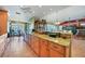 Open kitchen with granite counters, cabinets, tile floor, and adjacent dining and living spaces at 1200 Winward Ct, Punta Gorda, FL 33950