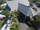 An aerial view of the building features palm trees, a metal roof, and an inviting entrance at 1286 Green Oak Trl, Port Charlotte, FL 33948