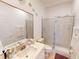 Bathroom with vanity, sink, mirror, and glass-enclosed shower at 1286 Green Oak Trl, Port Charlotte, FL 33948