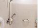 Accessible bathroom with shower, grab bar and neutral tile at 1286 Green Oak Trl, Port Charlotte, FL 33948