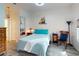 Comfortable bedroom featuring wood-look floors and a nautical accent at 1286 Green Oak Trl, Port Charlotte, FL 33948