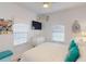 Bright bedroom with ceiling fan, two windows, and white dresser at 1286 Green Oak Trl, Port Charlotte, FL 33948