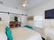 Bright bedroom featuring white walls, ceiling fan and a sliding barn door to the living room at 1286 Green Oak Trl, Port Charlotte, FL 33948