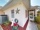 Charming home exterior with landscaped garden, window shutters and a quaint screened-in entryway at 1286 Green Oak Trl, Port Charlotte, FL 33948